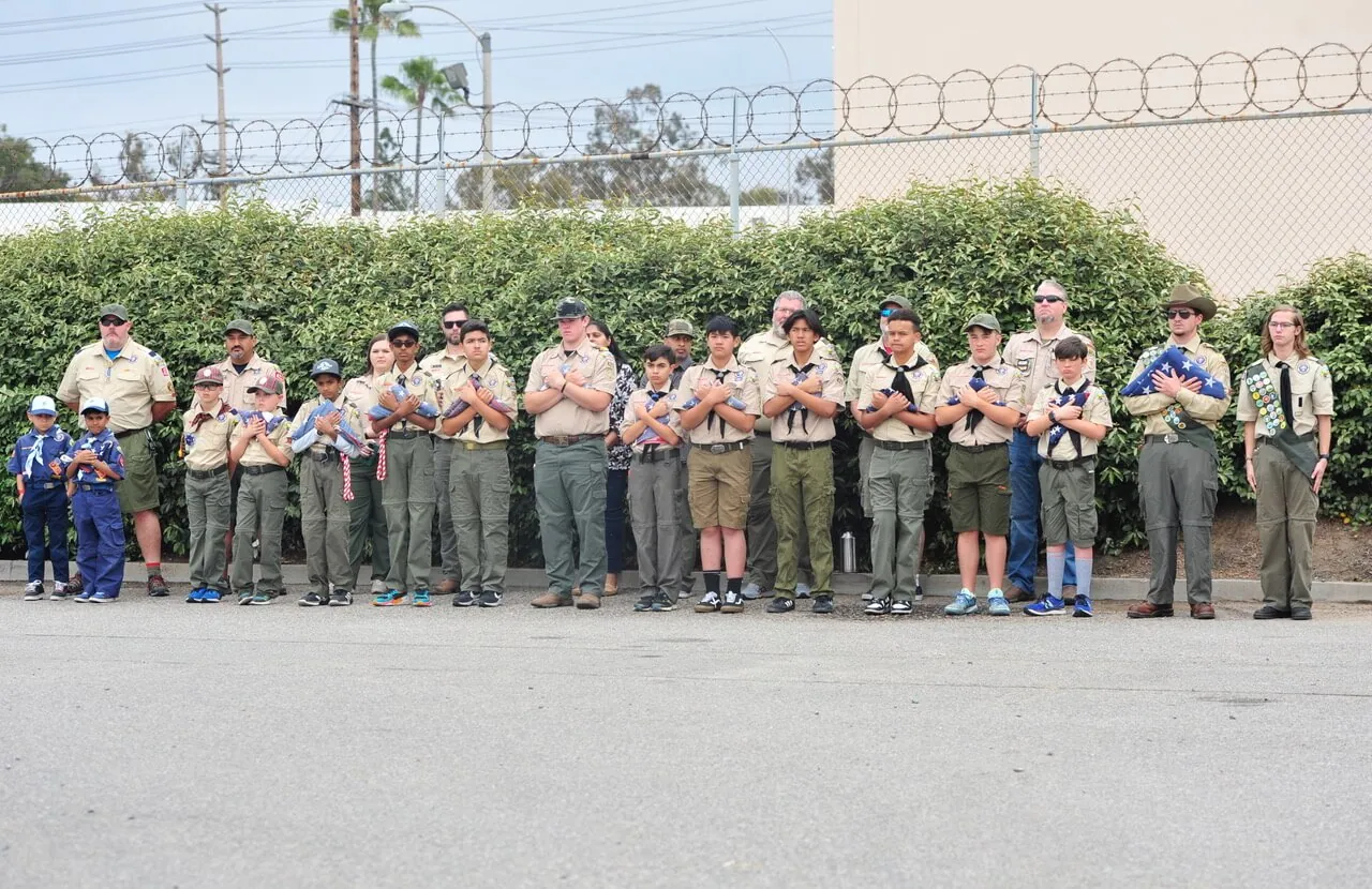 Corona Observes Flag Day. Boys Scouts and Cub Scouts salute during Flag Day ceremony Saturday at the Corona Fire Training Center. Credit: Photo by Jerry Soifer