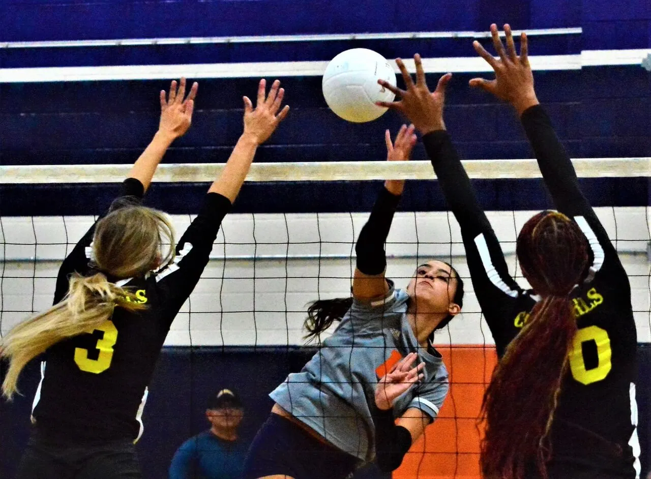High School Sports Returns. Eastvale Roosevelt’s Celeste Paez (center) spikes the ball between two Cajon defenders during the Mustangs 3 – 0 Victory over the Cowgirls.