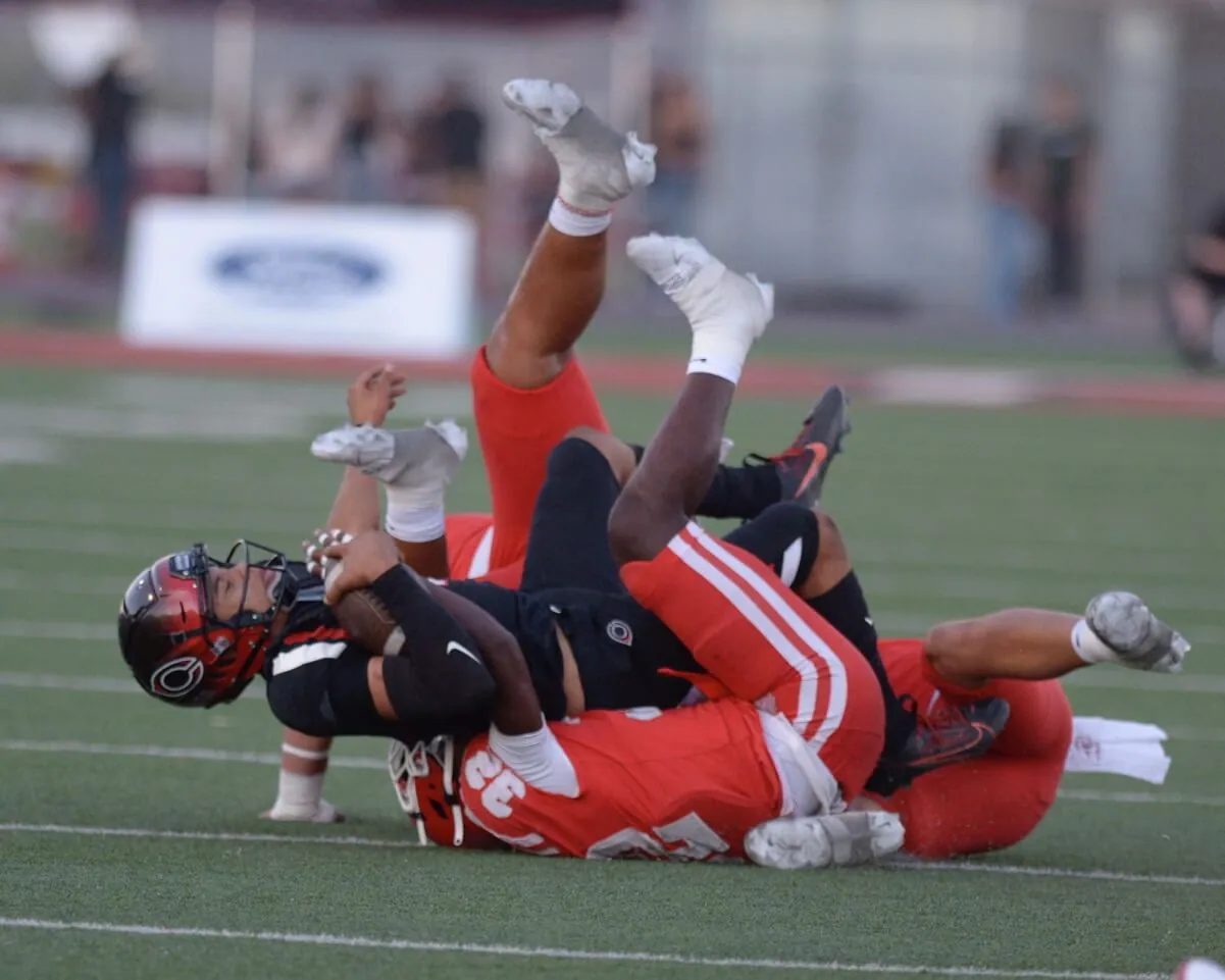 The Santa Ana Mater Dei defense sacked Corona Centennial quarterback Hula Longstreet eight times, in the Monarchs season-opening win over the Huskies 28-14. Credit: Photo by Jerry Soifer