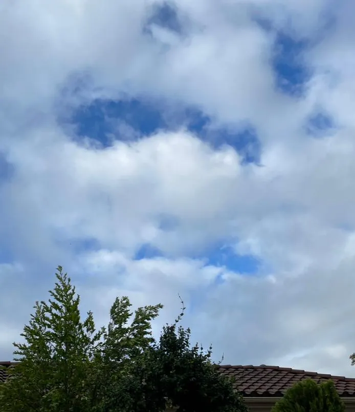 Ms. Hilary, the weakening tropical storm cloud still scowls down on the rain-soaked San Corgonio Pass Monday morning. But she cannot hide the blue skies that vow to reclaim soon their rightful summer. Don Ray’s “Ray of Light” photo.