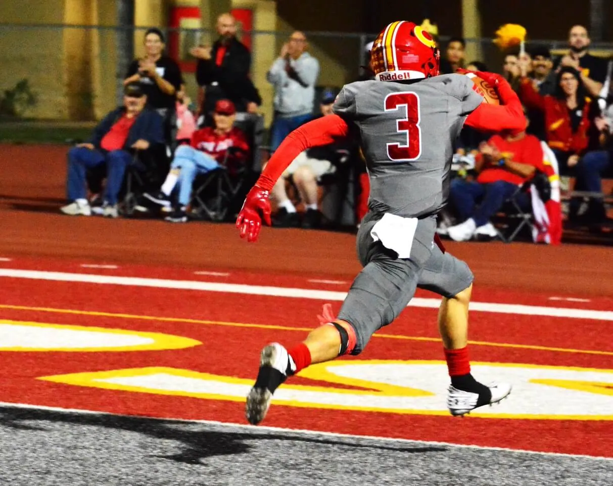 Corona’s Drake E Burkhart (3) glides into the endzone after catching a 20-yard pass from Quarterback Ty Owens and running 40 more yards for the score during the Panthers 41 – 14 victory over the Rancho Alamitos Vaqueros.
Credit: Photos by Gary Evans