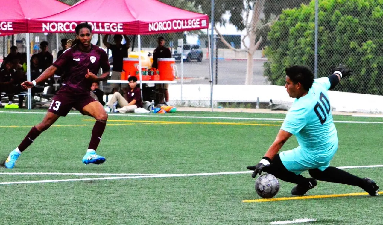 Norco College’s Kyle Shiroma (13) gets a shot past Moorpark goalie Billy Periez (00) during the Mustangs 7 – 0 rout of the Raiders.
Credit: Photo by Gary Evans