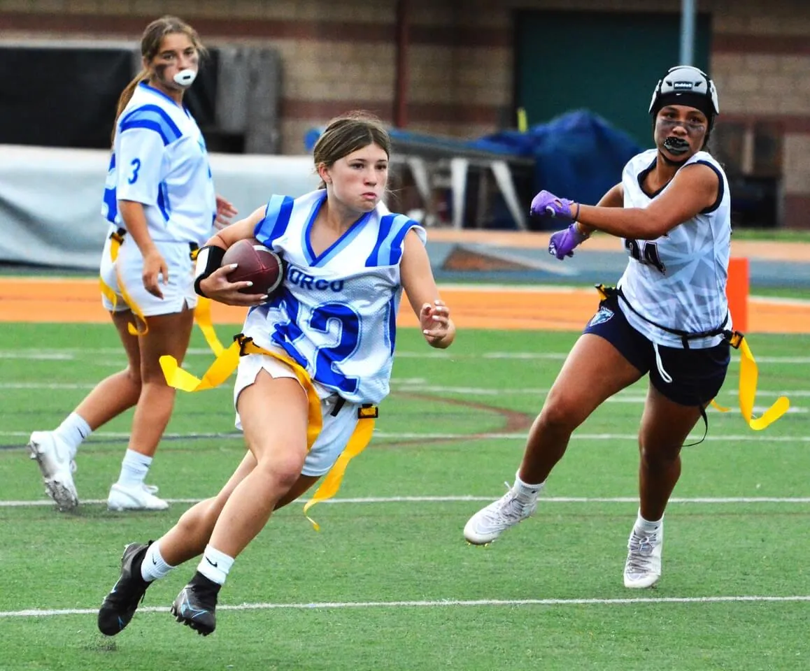 Norco’s Ashley Canales (22) looks for running room after taking a handoff from QB Mya Arrriola (3) while a King defender chases.  The Wolves defeated the Cougars 25 – 24.
Credit: Photo by Gary Evans
