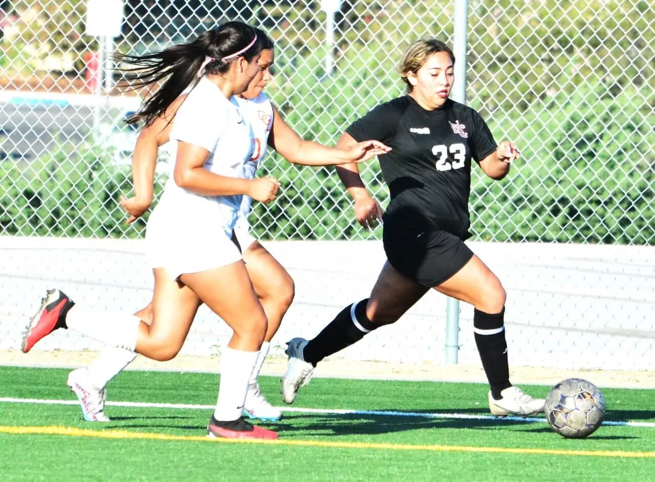 Norco College’s Kaitlyn Sagastume (23) makes her way past two Pirate defenders during the Mustangs 1 – 0 loss to Orange Coast College.
Credit: Photo by Gary Evans