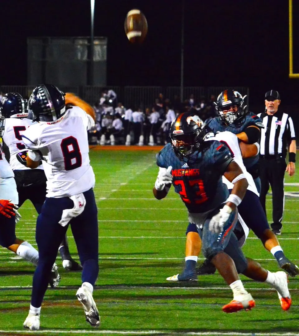 Ontario Colony QB Jacob Montoya (8) heaves a pass that was intercepted by Eastvale Roosevelt’s Brandon Perez (33). The Mustangs scored several plays later to defeat the Titans 38 – 31
Credit: Photo by Gary Evans