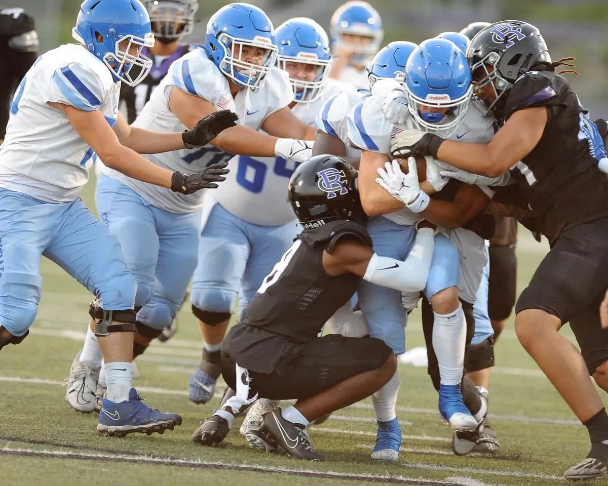 With a swarm of teammates pushing the cause, Norco running back Trevor Schneider fights for yardage.
Credit: Photo by Jerry Soifer