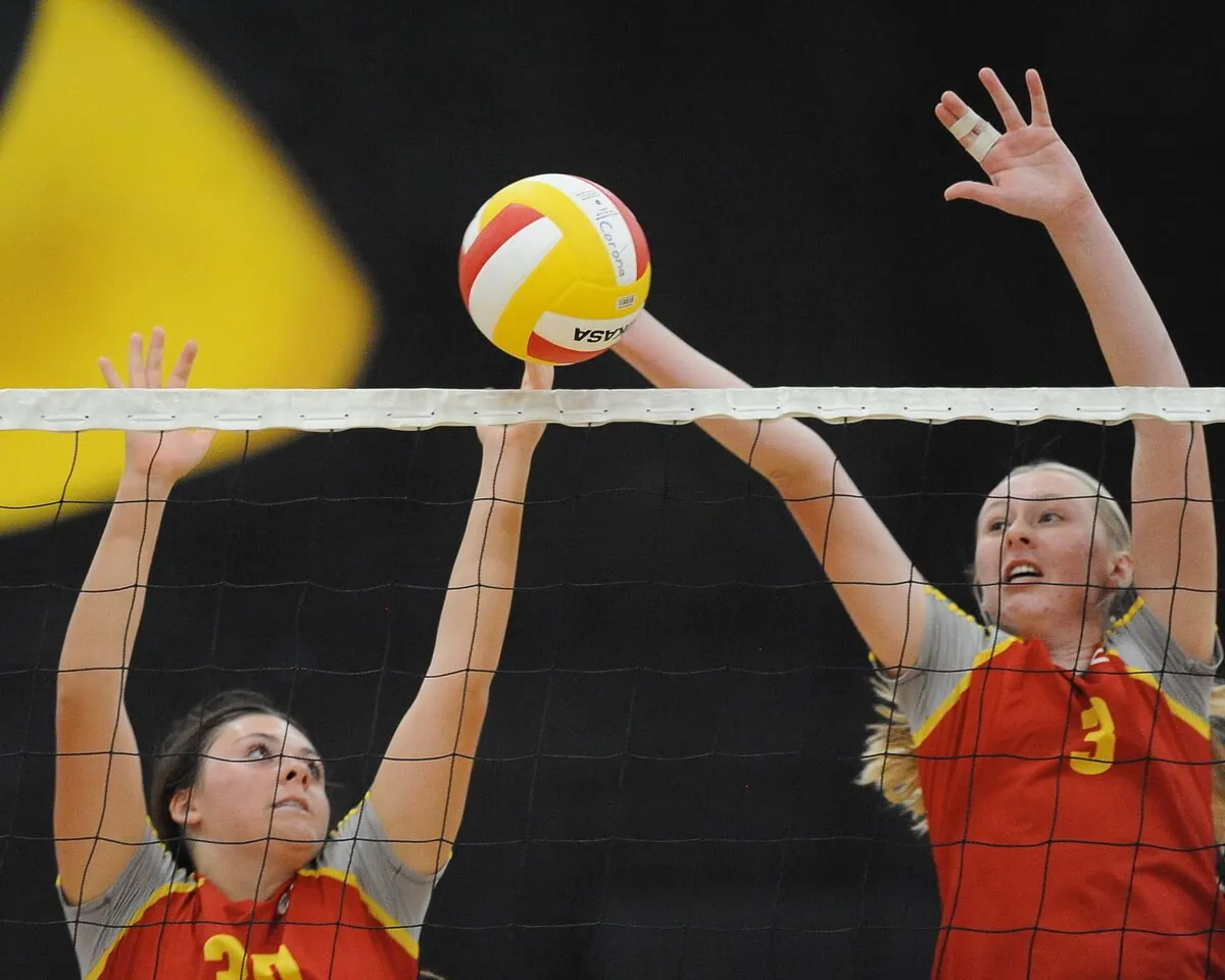 Corona High's Trinity Hovenier and Rebekah Harr attempt to block a Riverside Poly shot in a non-league volleyball match at Corona. Poly won, 3-0.
Credit: Photo by Jerry soifer
