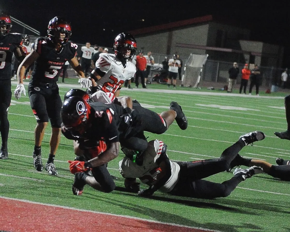 Centennial's Cornell Hatcher Jr. plunges into the end zone with seconds left to give the Huskies a 42-35 win over visiting Liberty of Arizona on Sept. 22.
Credit: Photo by Jerry Soifer