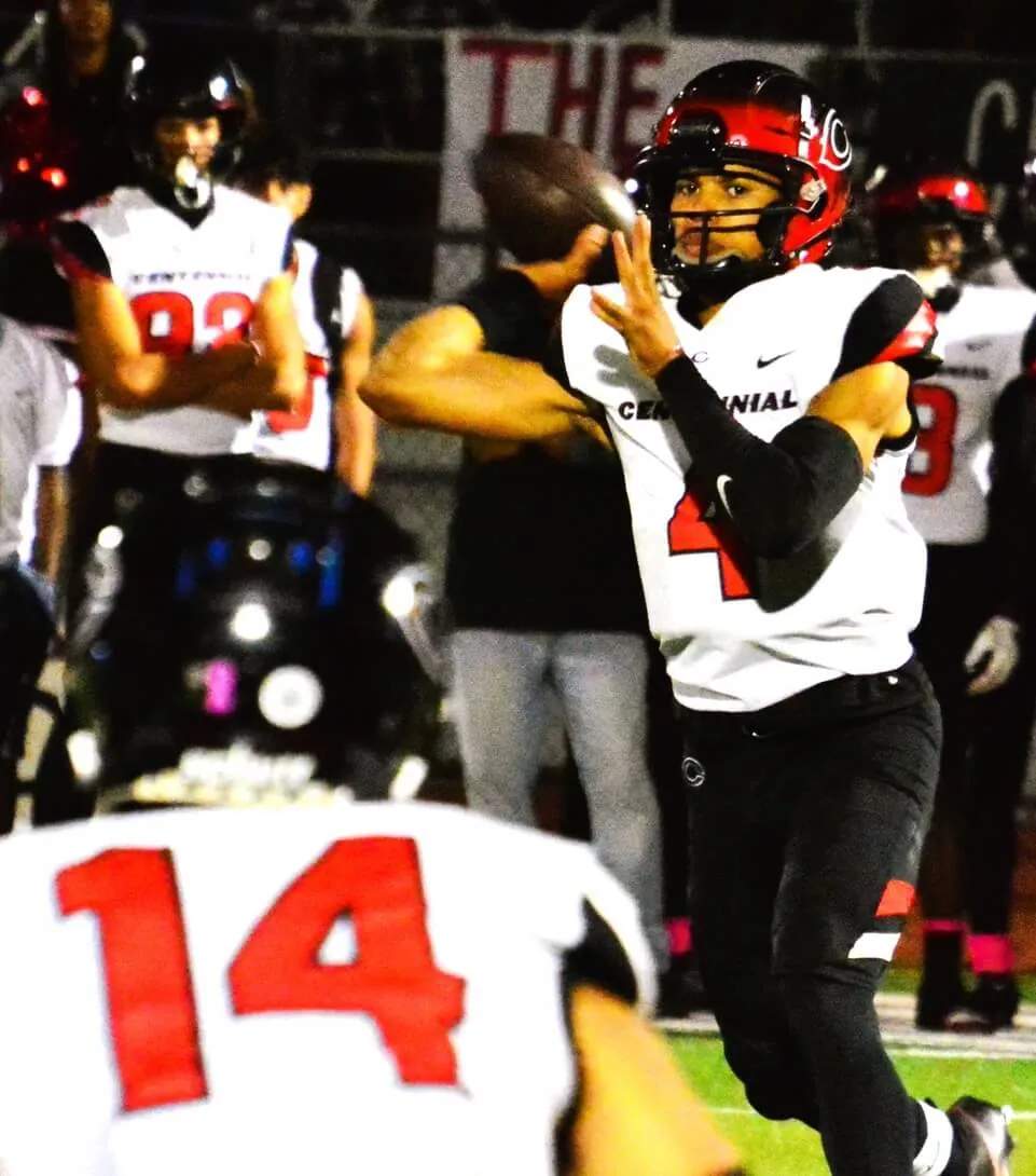 High School Sports Photos and Scoreboard 10/25. Corona Centennial QB Husan Longstreet (4) eyes receiver Noah Westbrook (14) during the Huskies 55 – 0 shutout over the Norco Cougars. Photo By Gary Evans
