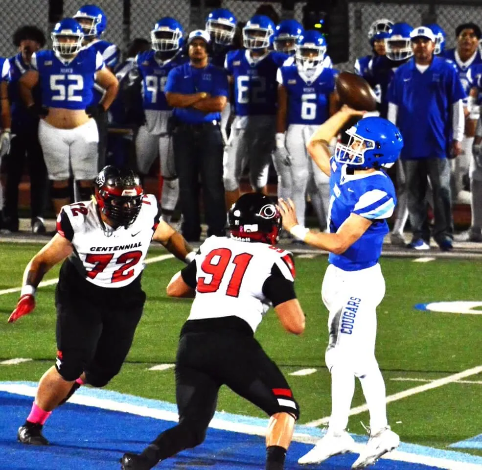Corona Centennial defenders Benjamin Tameifuna (72) and Blake Green (91) close in on Norco QB Joseph Stoffel (right) as Stoffel makes a jump pass completion. Photo by Gary Evans