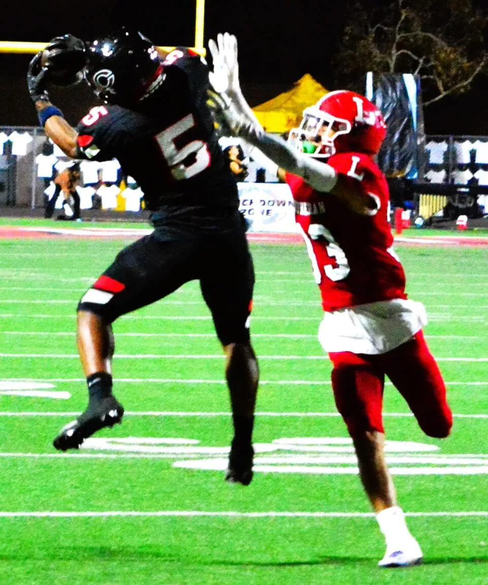 Corona Centennial’s Jason Harris Jr. (5) makes a leaping catch while Orange Lutheran’s Kanan Khansarinia (33) is a step behind. The Huskies routed the Lancers 63 – 39 in the CIF Division 1 quarterfinal. Centennial travels to top-seed St John Bosco tonight for the semi-final.
Credit: Photo by Gary Evans