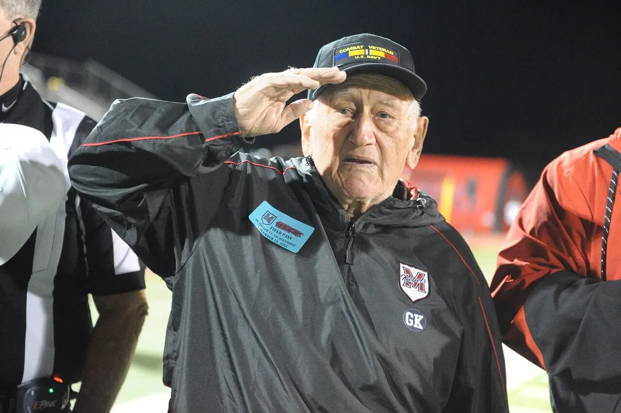 Navy veteran and former Corona resident Ozzie Omar, salutes during the national anthem prior to the Fontana A.B. Miller versus San Bernardino High Division 13 second round playoff game. Omar’s son Jeff is the Miller athletic director, who played for the 1989 Corona High team that won the first CIF football title in CNUSD history. San Bernardino defeated Miller, 44-27.
Credit: Photo by Jerry Soifer