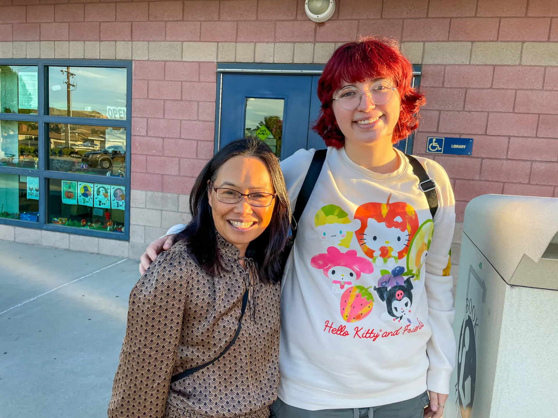 Riverside County Libraries. Though now in college, Emi Rose Barnett still visits and lends a hand to Nancy Reiter and staff. Credit: Photo by Don Ray
