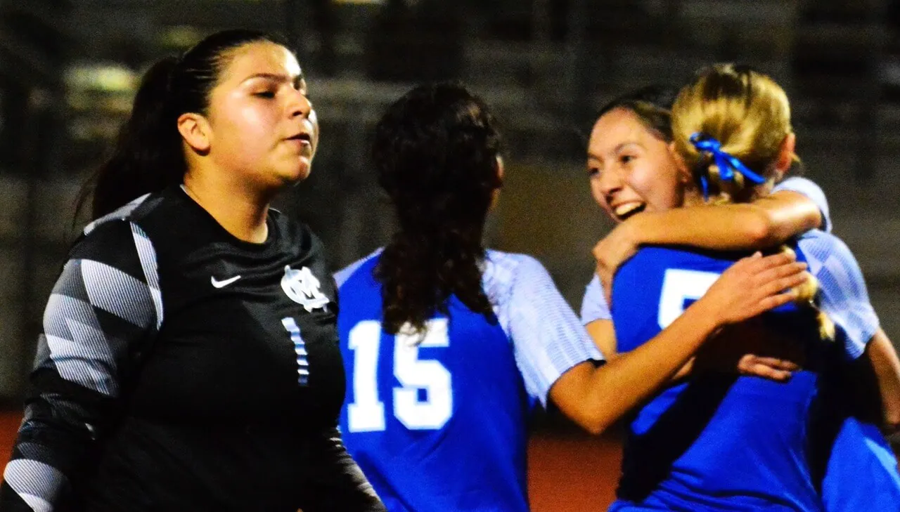 Montclair goalie Ariana Zepeda (left) grimaces while Norco’s Toni Backus (15), Audrina Ponce (smiling in center) and Jaylin Young (right) celebrate after Young scored past Zepeda.
