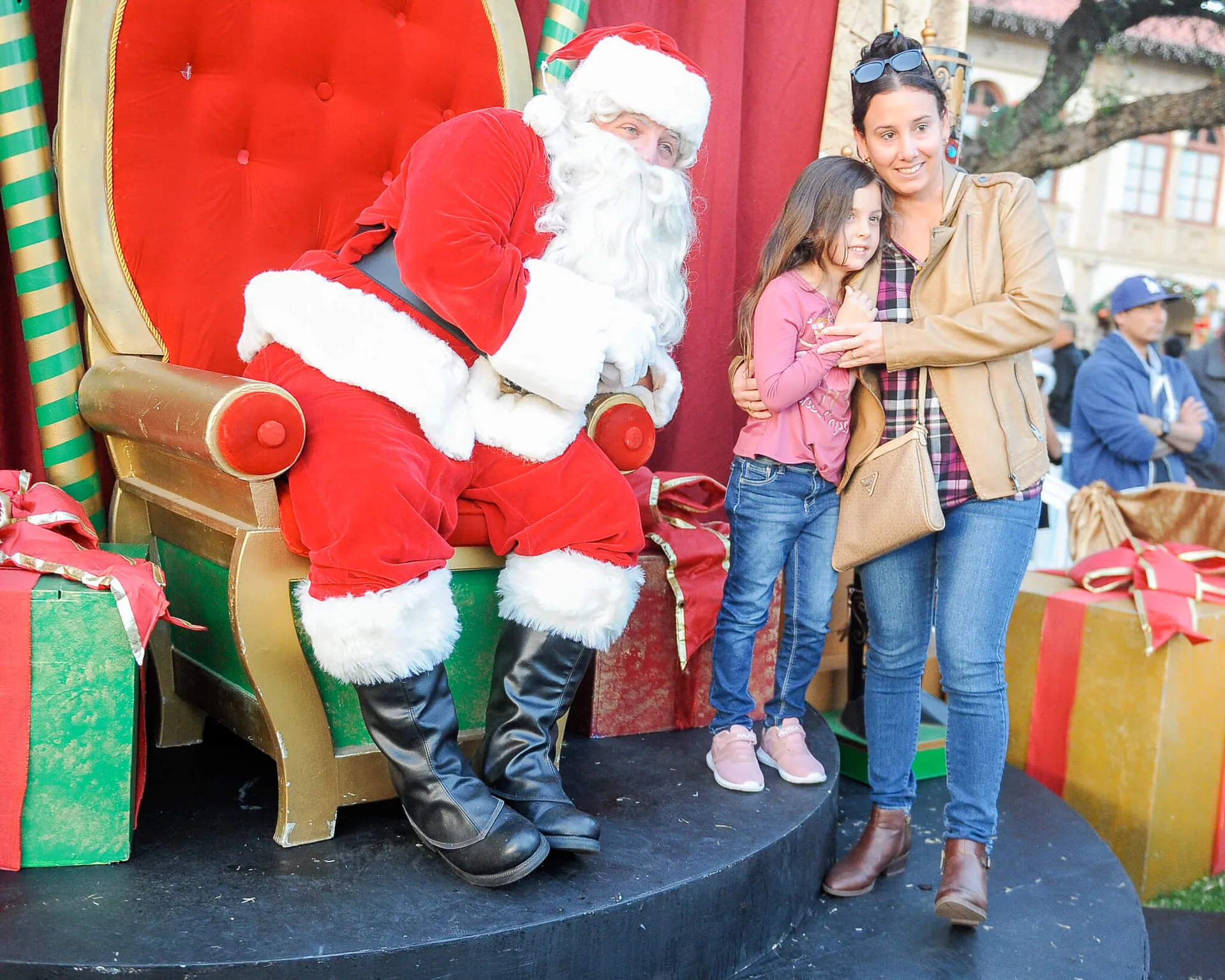Santa Claus visits with Luny Morales and her daughter, Lucia, 4, at the City of Corona's holiday festival. at the historic civic center. More festival photos on P6
Credit: Photo by Jerry Soifer