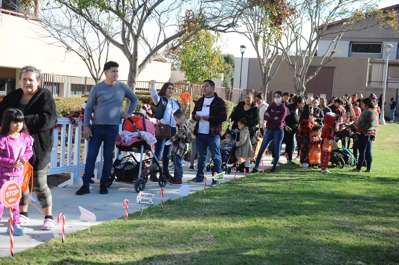 Children and adults wait with great anticipation for an audience with North Pole visitors, Santa and Mrs. Claus.