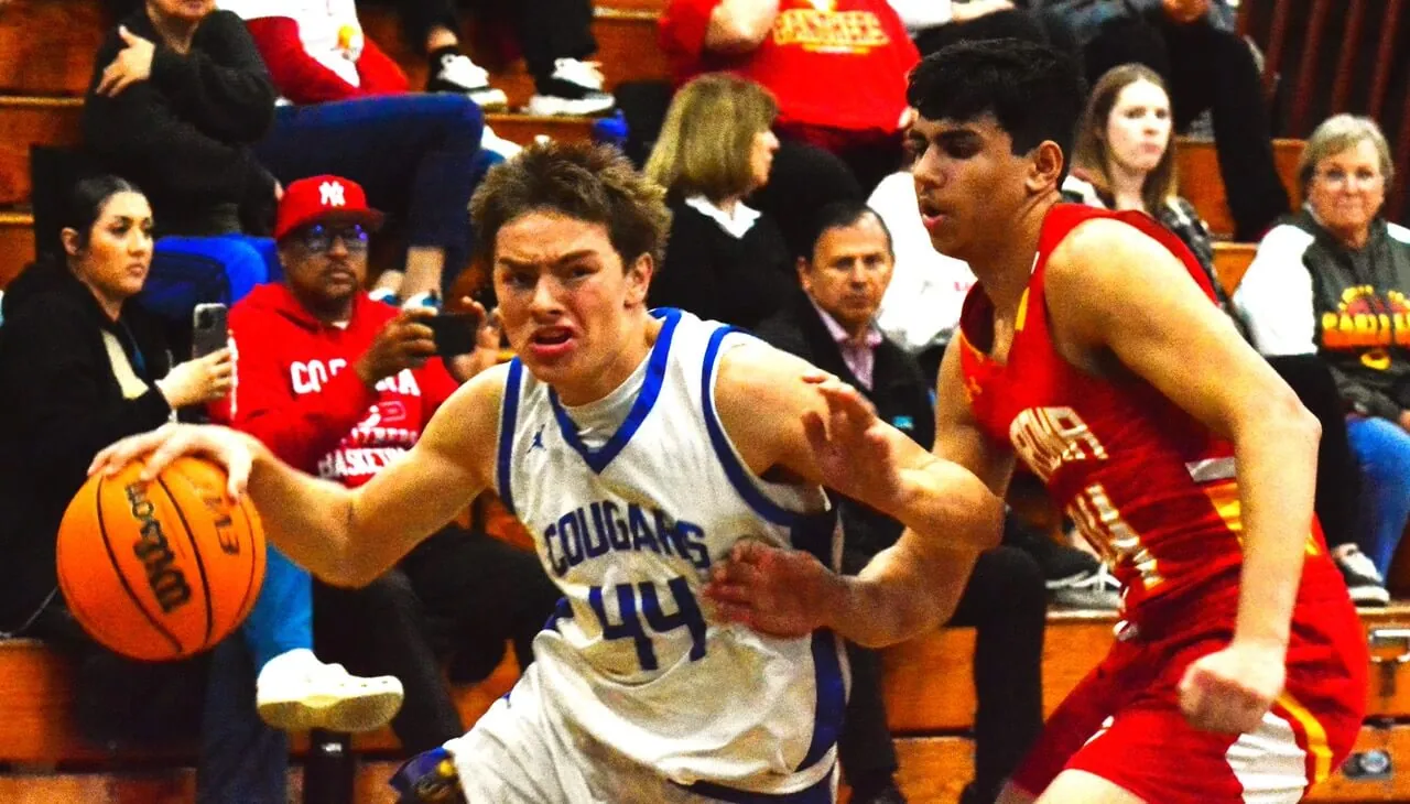 Norco’s Matthew Mendias (44) drives around Corona’s Brian Bedoy (24) during the Cougars 83 – 74 victory over the Panthers to close out the regular season.
Credit: Photo by Gary Evans
