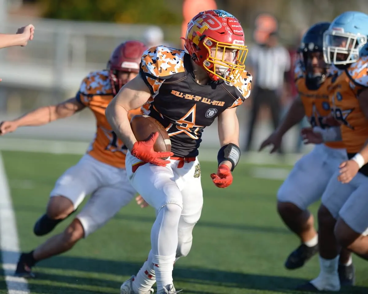 Daniel Mendoza, of Hemet, looks for yardage as he carries the football for the Riverside County All-Sar team against San Bernardino County in a game at Rubidoux High School on Saturday. San Bernardino won, 35-14. Photo by Jerry Soifer