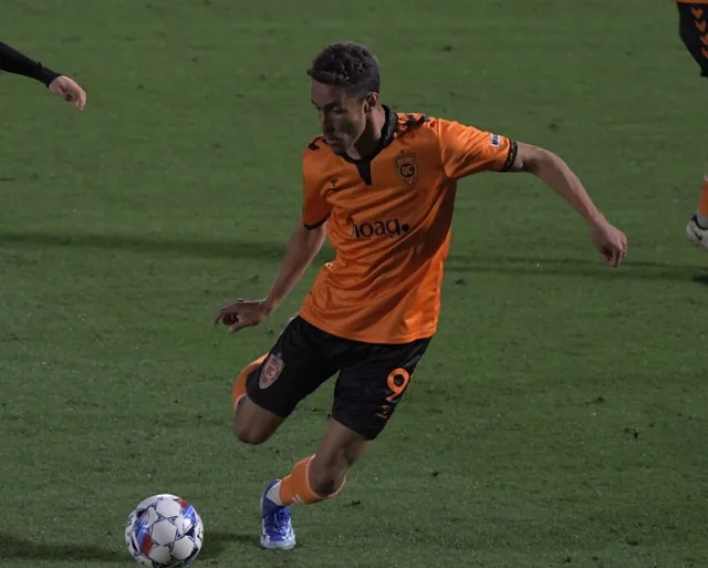 Corona's Ethan Zubak dribbles the ball late in the Orange County Soccer Club's 1-0 win over visiting Tulsa at the Great Park in Irvine Saturday.