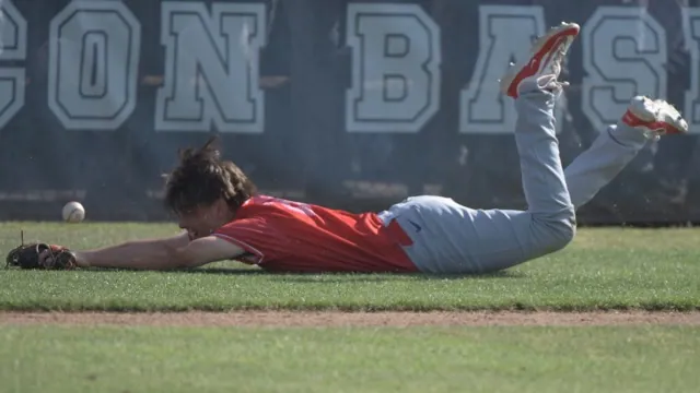 Corona third baseman Brady Ebel lies in the dirt in foul territory after failing to glove a pop foul in Friday's CIF Div. 1 quarterfinal game at San Bernardino Aquinas. Corona won, 6-4.