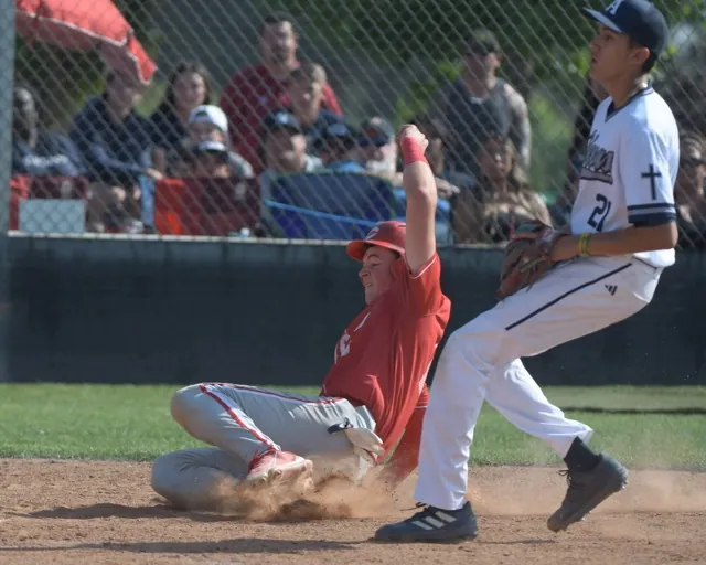 Corona's Josh Springer scores on a wild pitch as San Bernardino Aquinas' Landon Young is late covering home plate.