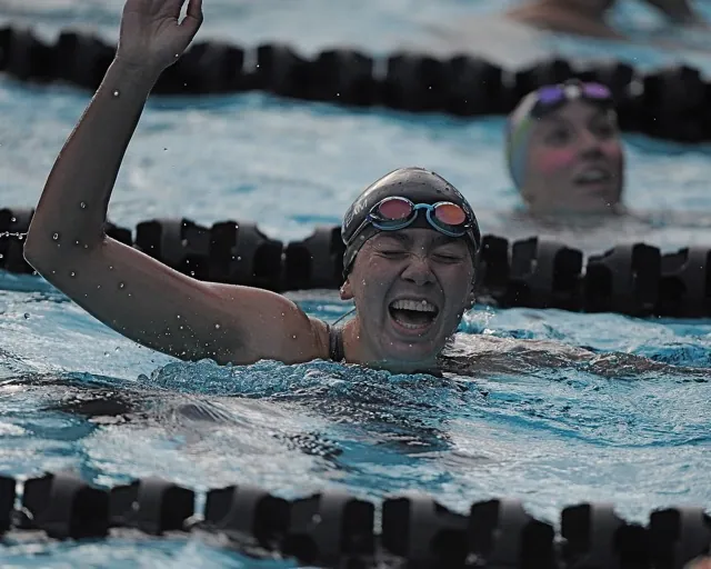 Corona Santiago's Madison Ham celebrates her win in the 100-yard backstroke.