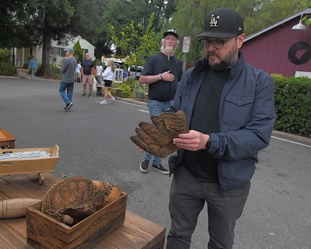 Thousands attended the Corona Heritage Park Antiques & Collectibles Faire on Saturday. Gilbert Elias holds vintage baseball gloves that were on sale.
Credit: Photo by Jerry Soifer