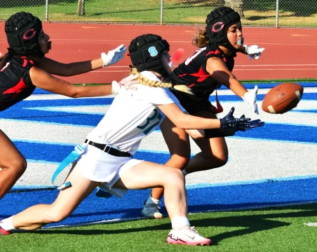 Corona Santiago’s Gracie Weinrick (center) is about to catch an extra point attempt while Centennial’s Giselle Maldanado (left) and Brystal Albright (right) defend. Weinrick fell at the one yard line.
Credit: Photo by Gary Evans