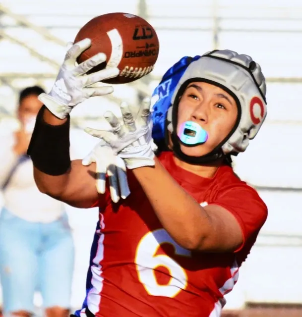 Corona’s Ava Liaga (6) hauls in a pass in front of a Norco defender in the Panther’s 13 – 7 victory over the Cougars, in a rematch of last season’s championship game, also won by Corona.
Credit: Photo by Gary Evans