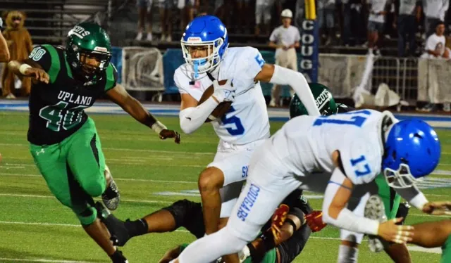 Upland’s Noah Guerrero (40) closes in to tackle Norco’s Blake Long (5) while teammate Lincoln Longfellow (17) buries a Highlander with a block.
Credit: Photo by Gary Evans