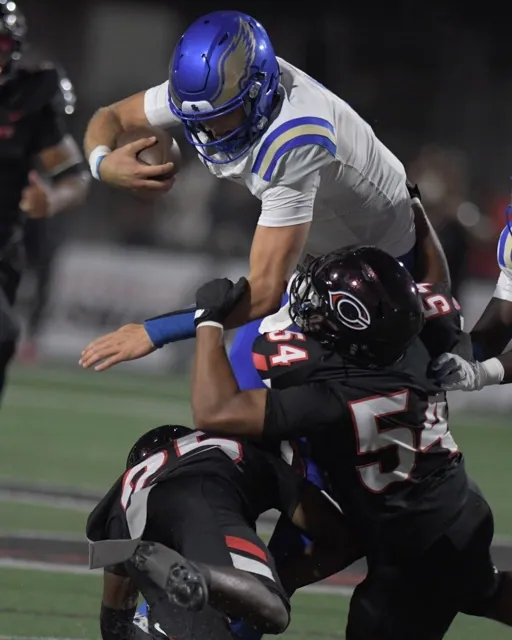 Santa Margarita quarterback John Gazzaniga goes up and over Corona Centennial in the first half of a non-league game at Centennial Aug 30. Santa Margarita upset the Huskies, 31-15.
Credit: Photo by Jerry Soifer