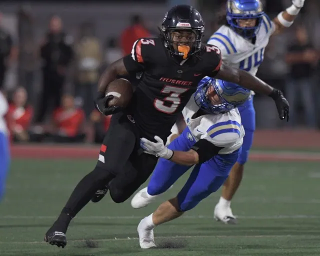 Corona Centennial running back Malachi Roby tries to break a tackle.
Credit: Photo by Jerry Soifer