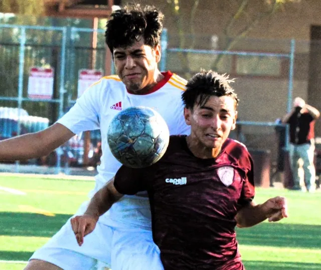 College of the Desert’s German Castro (left) and Norco’s Vinicus Gonclaves (right) collide while chasing down a pass during the first half of the Mustang match against the Road Runners.
Credit: Photo by Gary Evans