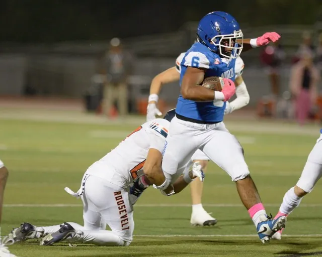 Norco running back Chris Laing tries to escape the grasp of a Roosevelt tackler.
Credit: Photo by Jerry Soifer
