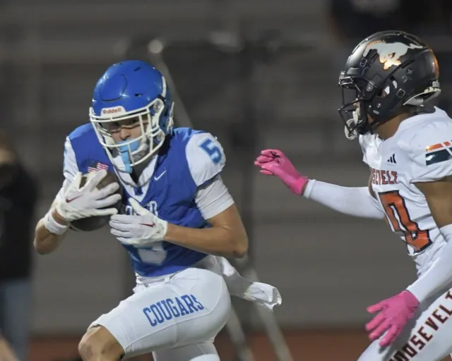 Norco's Blake Wong gains yardage after hauling-in a long pass to help the Cougars defeat visiting Roosevelt.
Credit: Photo by Jerry Soifer
