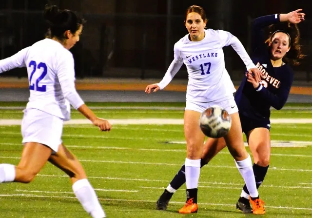Westlake’s Tahirih Vahdat (22) kicks the ball downfield while teammate Calista Banihashemi (17) blocks Eastvale Roosevelt’s Emma Gause (right from the ball). The Warriors knocked the Mustangs out of the CIF playoffs with a 2 – 0 victory.
Credit: Photo by Gary Evans