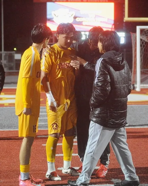 Corona boys’ soccer team members console each other after losing their Div. 1 playoff game with Villa Park, 2-1 in overtime last Thursday. The match was played in drenching rain.
Credit: Photo by Jerry Soifer