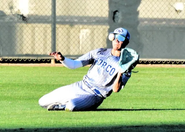Norco centerfielder Elijah Alvarez makes a great sliding catch staring into the sun in the second game of the series against Corona.  The Panthers swept the series against the Cougars, 9 – 0, 4 – 0 and 5 – 0