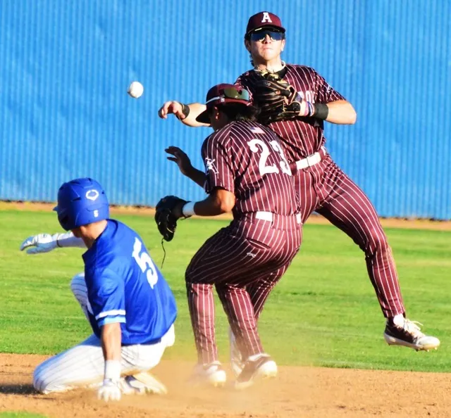Featured Photos March 7, 2025. Norco’s Gavin Smith (5) is forced out at second by Arlington’s shortstop Luca Lombardi (right) while second baseman Joe Flores (23) ducks. Lombardi’s throw to first was late to double up the batter, and the Cougars doubled up the score on the Lions, 6 – 3. Credit: Photo by Gary Evans
