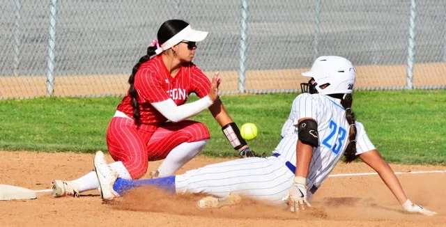 Corona Third baseman Madison Mejia (left) can’t handle the relay throw while Norco’s Ashley Duran (right) slides in safe with a triple.
Credit: Photo by Gary Evans
