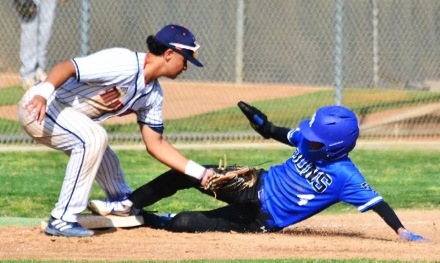 Eastvale Roosevelt third baseman Dominic Lemos (left) is late with the tag while El Rancho’s Adrian Rojas (4) slides in safely. The Dons defeated the Mustangs 2 – 1.
Credit: Photo by Gary Evans