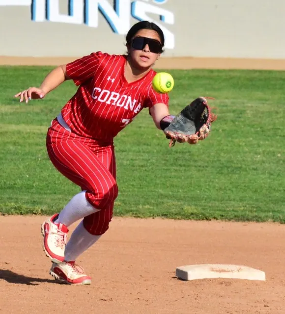 Featured Photo's 03-28-2025. Corona shortstop Nicole Ramirez snags a soft liner over the middle for an out against Norco. The Cougars defeated the Panthers 11 – 0. Credit: Photo by Gary Evans