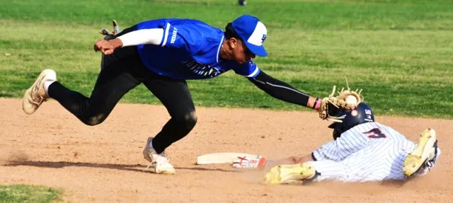 El Rancho shortstop David Aguirre (left) appears to miss the tag on Eastvale Roosevelt runner Andrew Taylor (3), but the umpire called Taylor out during the Dons 2 – 1 win over the Mustangs.