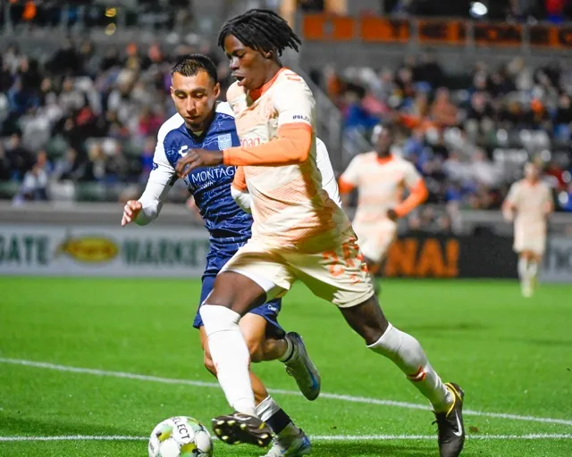3-28-2025. Orange County Soccer Club forward Benjamin Barjolo brings the ball upfield Saturday against Monterey Bay's Alex Dixon in a USL game at Great Park in Irvine. Monterey Bay won, 3-0. Credit: Photo by Jerry Soifer