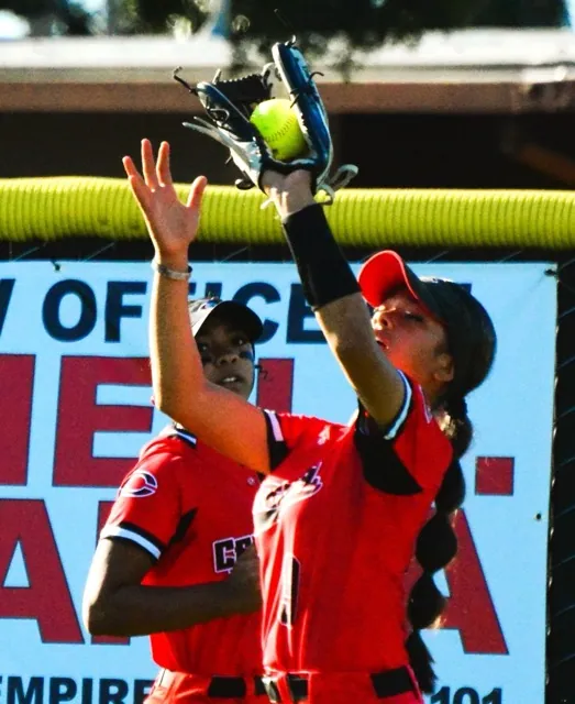 Centennial right fielder Nele Sanchez makes the 5th inning ending catch against Norco while centerfielder Alanah Cole backs up the play.  The Cougars defeated the Huskies 4 – 2
Credit: Photo by Gary Evans
