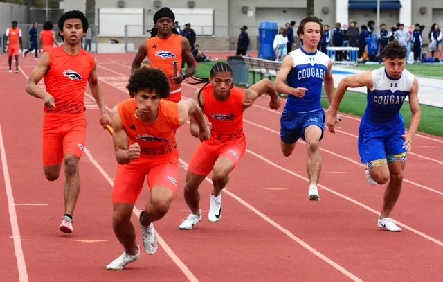 Roosevelt and Norco relay teams pass the baton in the 4 X 100 race. Rooseveltʻ squad on the left won, Norco tool second place.
Credit: Photo by Gary Evans