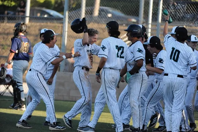 Santiago players celebrate Sharks 5-4 comeback win in the eighth inning over visiting Eastvale Rosevelt in a Big VIII League game.