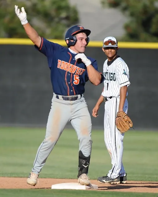 Roosevelt's Dominic Diaz celebrates his double at second base as Santiago's second baseman Ben Rausch looks on. Santiago won, 5-4, in eight innings.
Credit: Photo by Jerry Soifer
