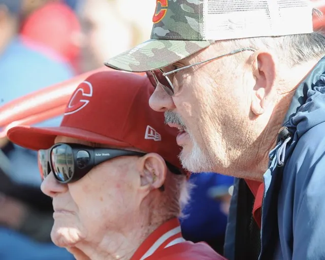 Retired, legendary Corona baseball coach Lyle Wilkerson, left, watches with former teacher-coach Chuck Komrosky as the Corona baseball team defeats Riverside King, 21-0, in a Big VIII League game at Corona. High school sports, P16.