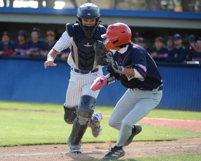 Norco catcher Wyatt Fiedler tags out Temecula Great Oak's Logan Washizaki in a rundown in the sixth inning of a Darryl Kile Tournament game Friday at Norco. Great Oak won, 4-0.
Credit: Photo by Jerry Soifer